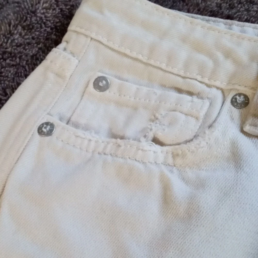 We the Free 27 waist cream colored five pocket distressed miniskirt